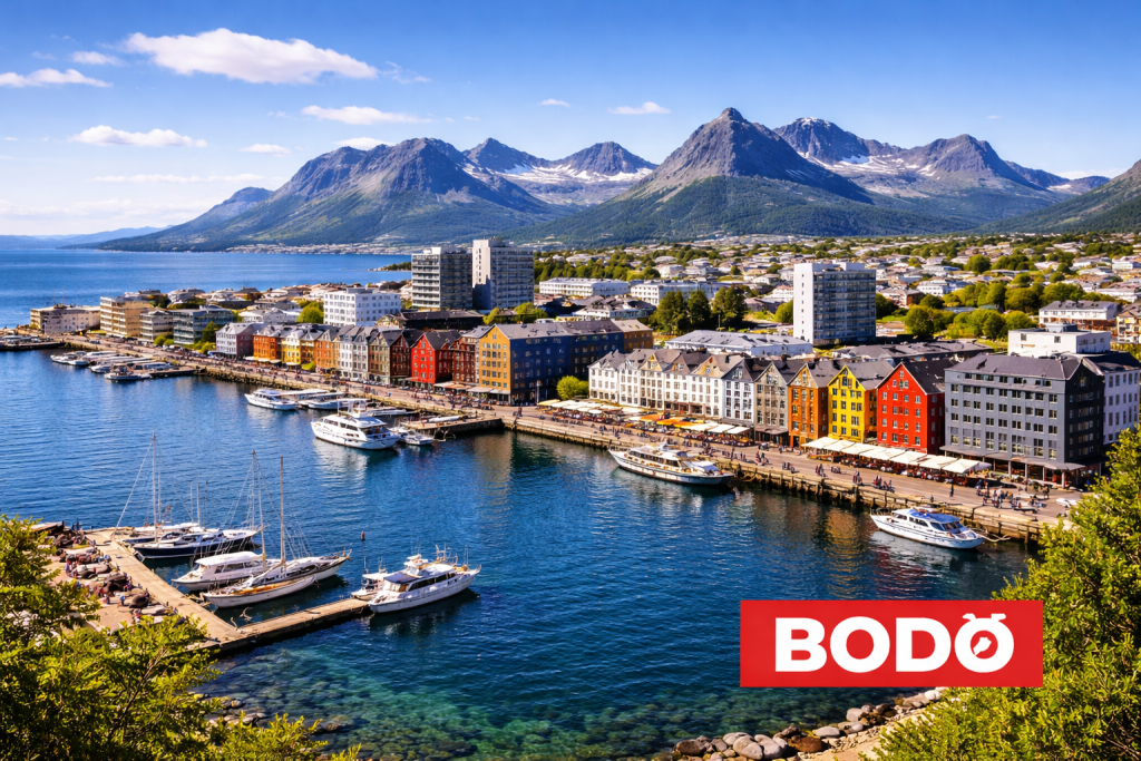 Hafen und Innenstadt von Bodø mit bunten Gebäuden und Bergen im Hintergrund bei klarem Himmel